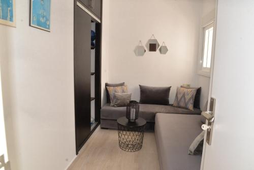 a living room with a couch and a table at la perle de martil in Martil