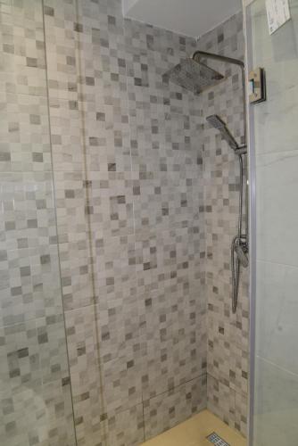 a bathroom with a shower with a glass door at la perle de martil in Martil