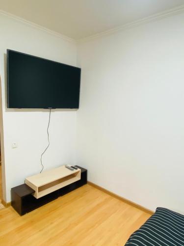 a room with a flat screen tv on a wall at В центрі міста класні апартаменти! in Cherkasy