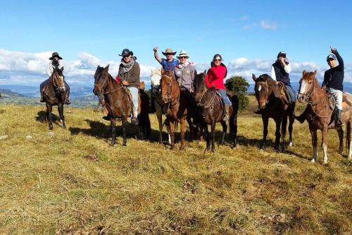 a group of people riding horses on a field at Un refugio en las montañas de Tabio in Tabio