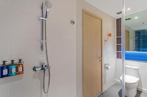 a bathroom with a shower and a toilet at Holiday Inn Express Dali Xiaguan by IHG in Dali