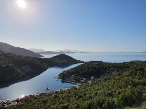 a view of a large body of water with mountains at Villa Albatross in Sivota