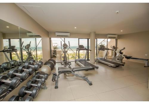 a gym with several treadmills and exercise bikes at Ela Beach Hotel in Port Moresby