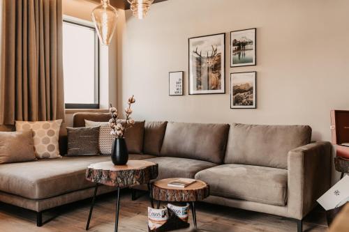 a living room with a couch and a table at Hoamat House I Boutique Apartments in Sankt Margarethen im Lungau
