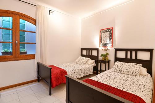a bedroom with two beds and a window at Villa Alex in Puerto del Carmen