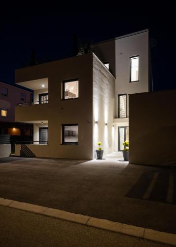 a large building at night with its lights on at Belvedere Holidays Villas in Novigrad Istria