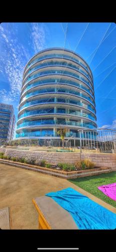 a large glass building with a blue at Luxury Ocean Spa Plaza Private Large 1 bed apartment in Gibraltar