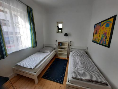 two beds in a room with a window at Ferienwohnungen-In-Bacharach in Bacharach