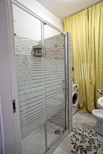 a glass shower in a bathroom with a toilet at Maison Floria Locazione Turistica in Pescara