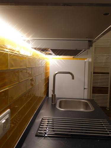 a kitchen with a sink and a light at Giudei House Loft 2 in Bologna