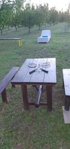 a picnic table with glasses on it in a park at Vinogradski konak Belgrade, Sopot,Kosmaj in Sopot