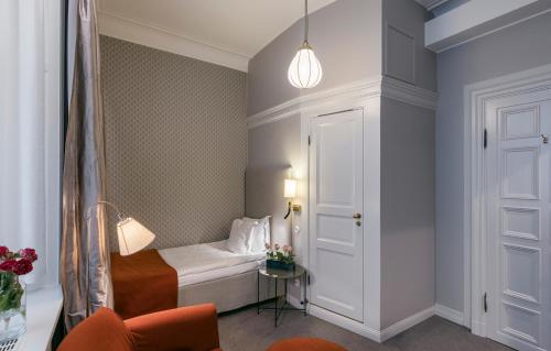 a small room with a bed and a table at Hotel Esplanade, BW Signature Collection in Stockholm