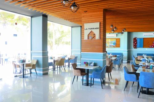 una sala da pranzo con tavoli e sedie in un ristorante di ALmansor furnished Apartment 1 a Salalah