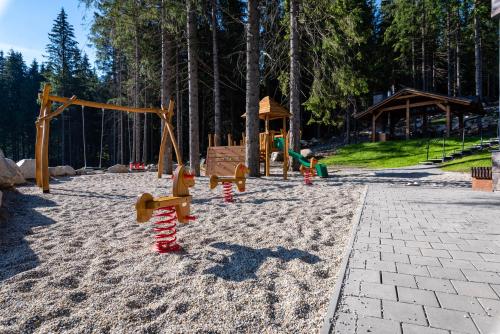 a park with a playground with a swing set at Hotel Björnson & Björnson TREE HOUSES Jasná in Demanovska Dolina