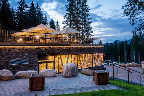 a building with a bar on top of it at Hotel Björnson & Björnson TREE HOUSES Jasná in Demanovska Dolina