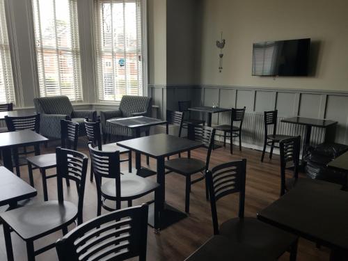 a dining room filled with tables and chairs at Kingswood Guest House in Stockton-on-Tees