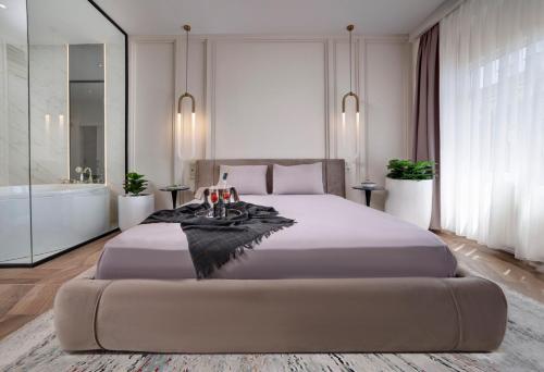 a bedroom with a large bed and a bath tub at Walton Gardens Pera in Istanbul