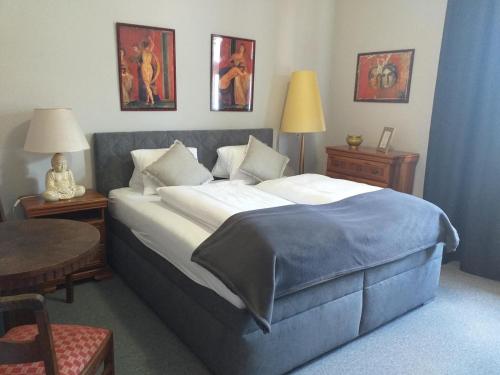 a bedroom with a large bed and a table and chairs at Pension Rainbow*** in Karlovy Vary