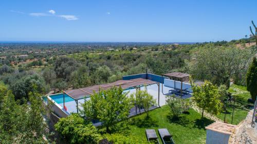an aerial view of a house with a swimming pool at Finca Agroturismo Es Pujol in Santanyi