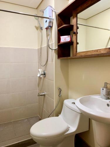 a bathroom with a toilet and a sink at Penthouse Condo Studio Unit CENTRIO TOWER w/ Stove in Cagayan de Oro