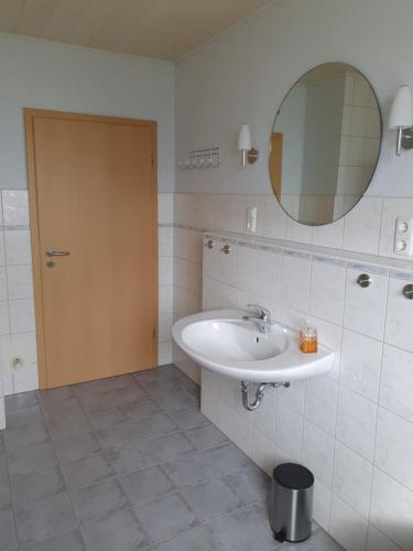 a bathroom with a sink and a mirror at Ferienhaus 7a in Munster im Heidekreis