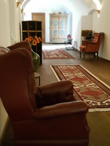 a living room with two chairs and a rug at Premium Residences Rauris incl Sommercard in Rauris