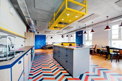 a kitchen with a colorful rug on the floor at MILESTONE by Tribera Gdańsk Center in Gdańsk