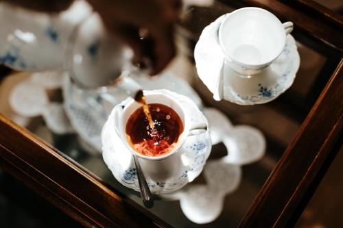 a cup of tea sitting on a saucer at Kosbor Panzió in Magyarszombatfa