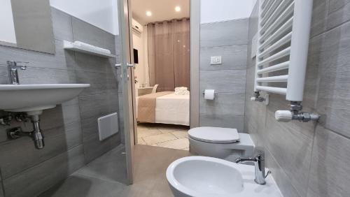 a bathroom with a sink and a toilet and a sink at Villa Vittoria in Mesagne
