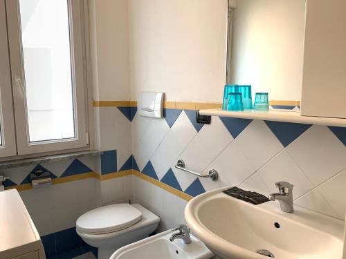 a bathroom with a white toilet and a sink at Case vacanze Miramare in Levanto