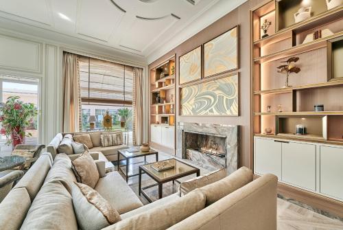 a living room with a couch and a fireplace at La Réserve de Beaulieu in Beaulieu-sur-Mer