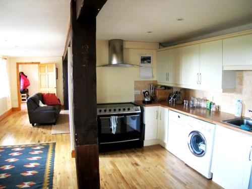a kitchen with a stove and a dishwasher at Lamphey Park in Lamphey