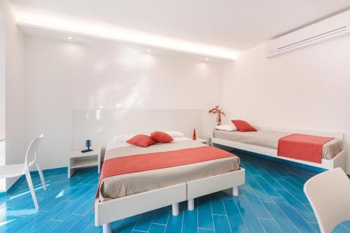 Postel nebo postele na pokoji v ubytování Il Corallo Residence