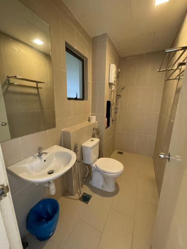 a bathroom with a sink and a toilet at Awin swiss garden residence in Kuantan