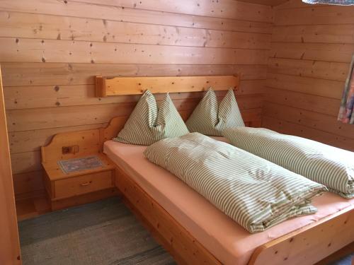 a log cabin with two beds in a room at Appartement Sonnberg in Forstau