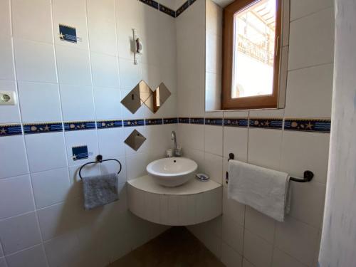 a small bathroom with a sink and a window at Vila Seascape in 2 Mai