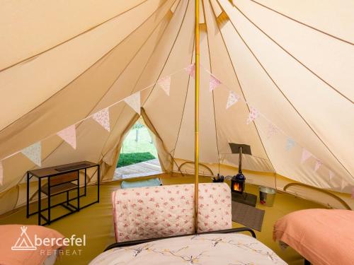 a tent with a chair and a table in it at Abercefel Retreat in Llandysul