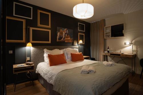a bedroom with a large bed with two towels on it at Les Demeures de Varennes, BW Signature Collection in Varennes-Jarcy