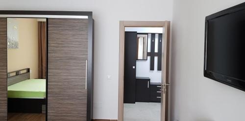 a room with a television and a door with a mirror at CASA LIVIA in Slatina