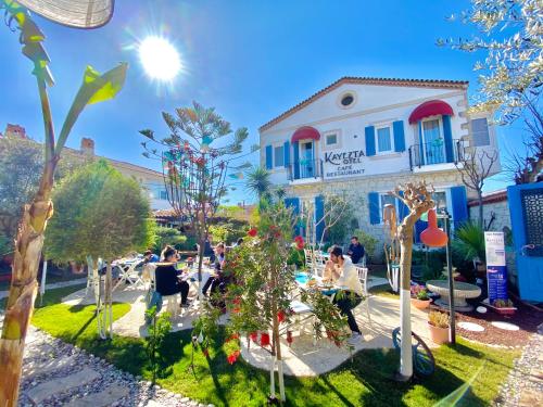 a group of people sitting in front of a building at Alacati Kayezta Hotel in Alacati
