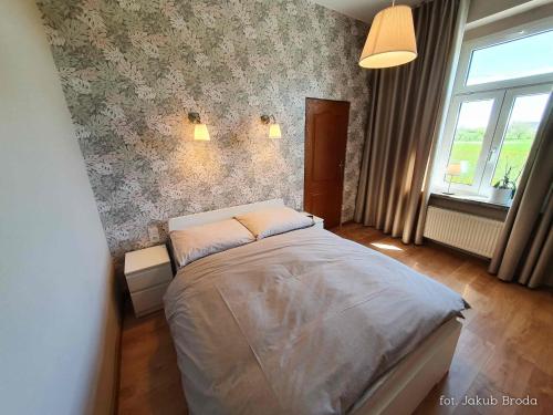 Posteľ alebo postele v izbe v ubytovaní Apartamenty Toszeckie 4-6 osób
