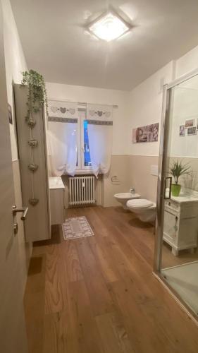 a bathroom with a toilet and a sink at Appartamento "Roby" in centro Cavalese in Cavalese