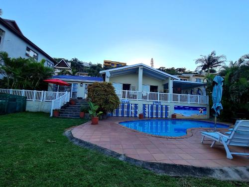 a house with a swimming pool in the yard at Ruby Sands Exclusive Holiday home in Ballito