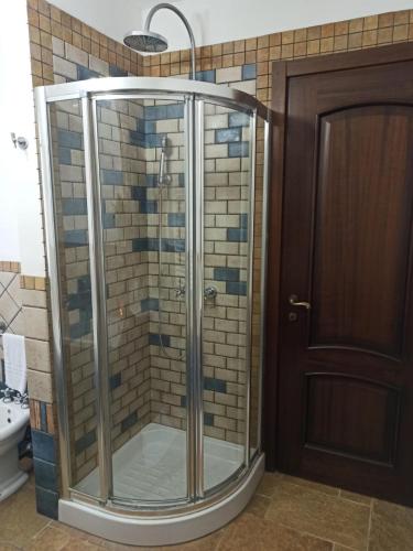 a shower with a glass door in a bathroom at Giardino di Circe in Agrigento