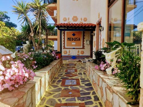 a tiled walkway in front of a building at Medusa Apartments in Katelios