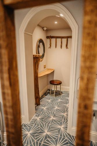 a hallway with an archway and a table and stool at The Ship Inn in Mundesley