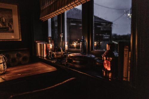 a dark room with a window and a table at The Ship Inn in Mundesley