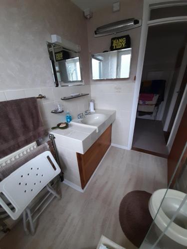 a bathroom with a sink and a mirror at Comfort House in Havant