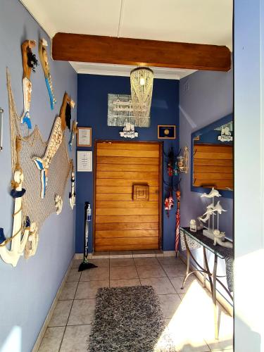 a room with a wooden door and some animals on the wall at Ruby Sands Exclusive Holiday home in Ballito