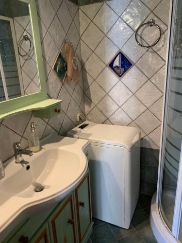 a bathroom with a sink and a toilet at Althea Garden House in Hydra
